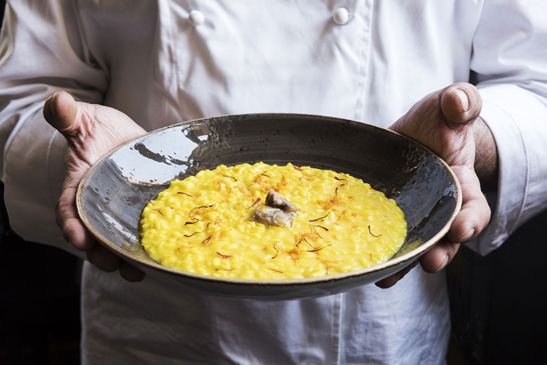 Saffron-infused risotto with orange and beef bone marrow by Ratanà
